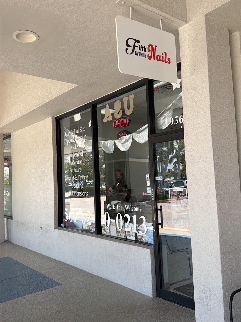 A clean nail salon with multiple workstations.